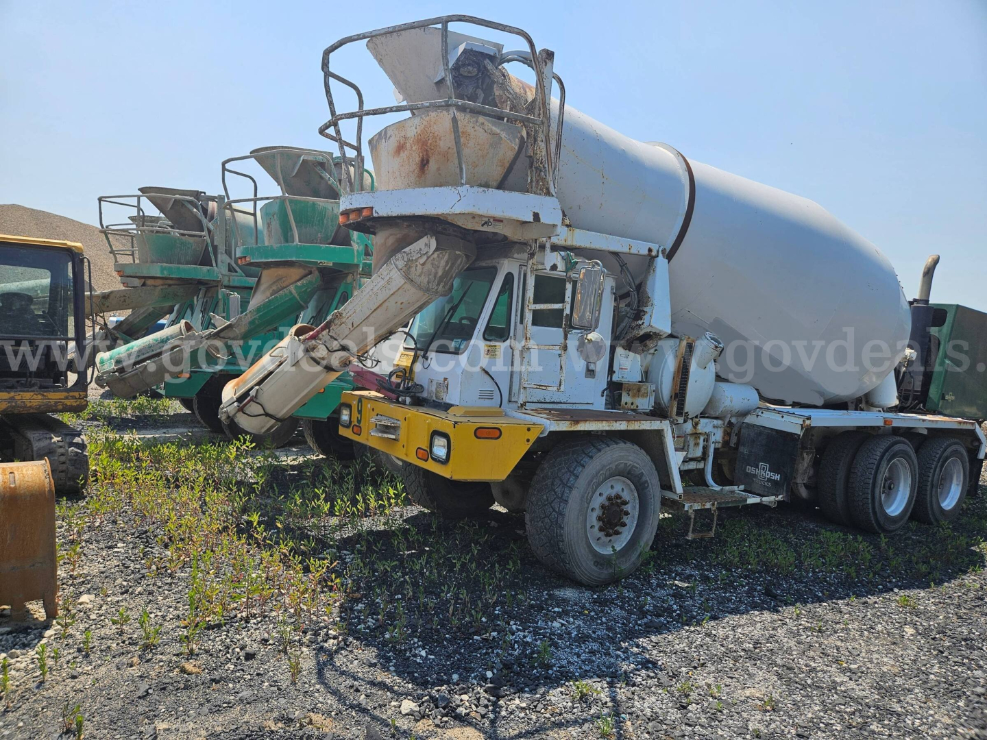 Concrete mixer truck in-service showing cement mixer and loading chute.