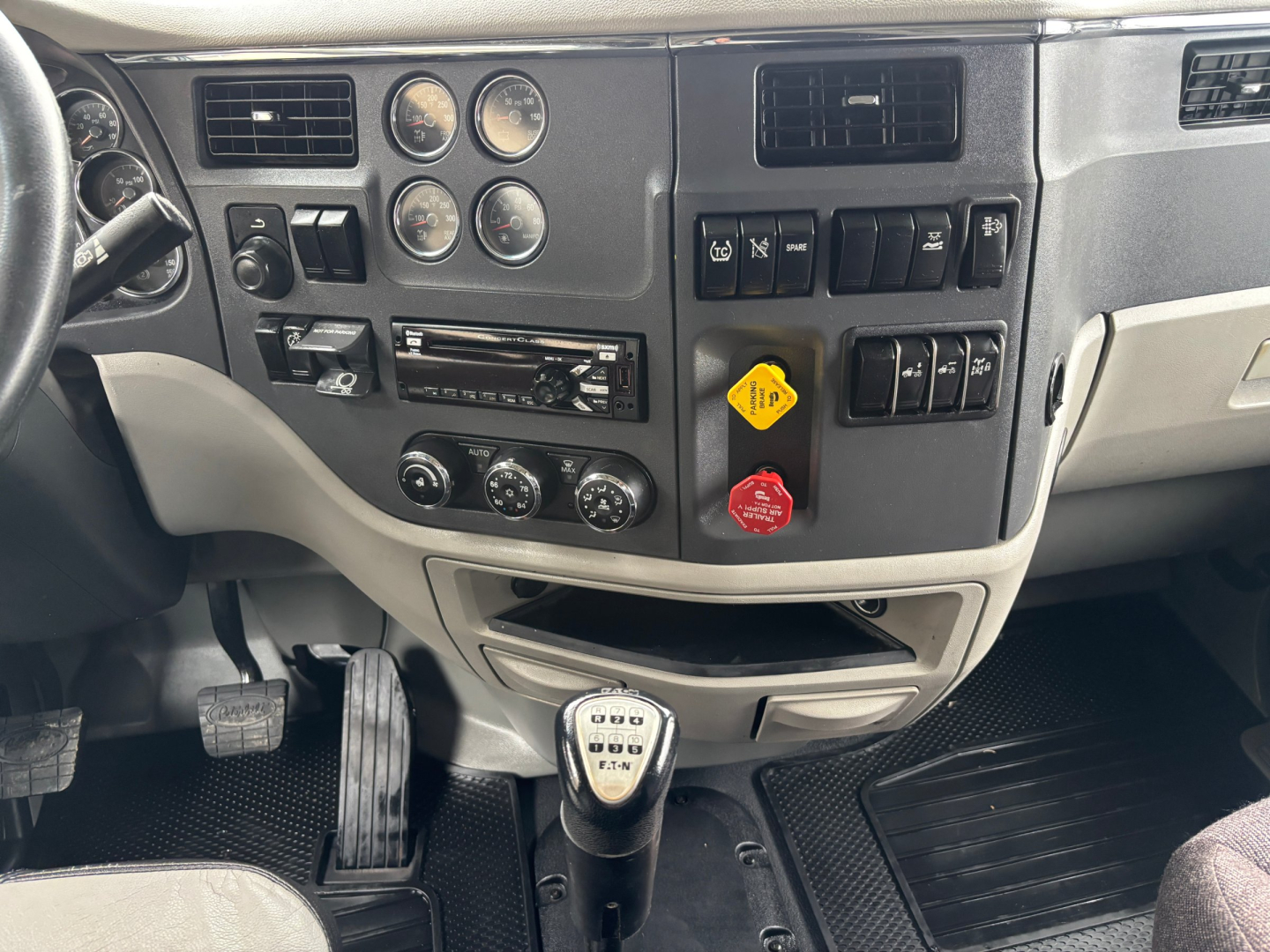 Peterbilt 579 interior dashboard with steering column, gauges, and gear shift in view