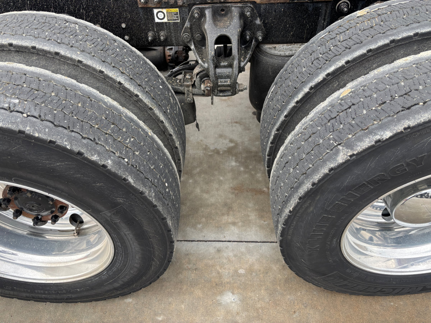Peterbilt 579 rear dual tires axle view showing chassis and suspension area.
