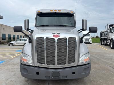 Peterbilt 579 front view showing grille, headlights, and bumper. Front badge and mirrors visible.