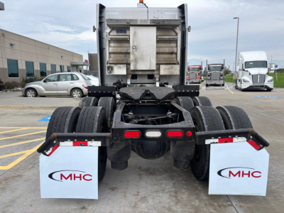 Rear view of a 2020 Peterbilt 579 tractor showing dual rear axles, fifth-wheel area, and MHC mud flaps with logo.