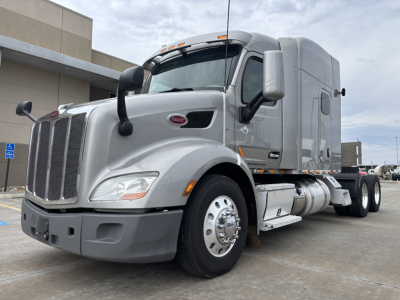 Peterbilt 579 conventional sleeper truck with chrome grille, large front bumper, and dual rear axles. Visible text includes Peterbilt badge on grille and cab, and images show VIN and stock not on the photo.