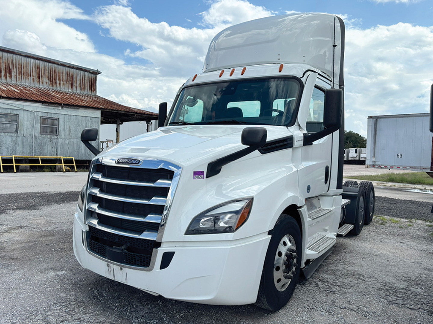 Truck cab showing Freightliner Cascadia 126 with grille and headlights, white exterior, freightliner logo, side mirrors, and front wheel area.