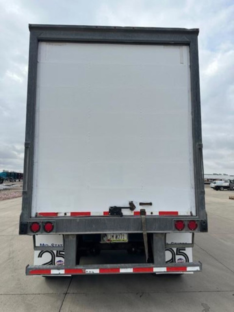Rear view of a Wabash van trailer showing back doors, taillights, and reflective tape; stock number U90814 and VIN visible.