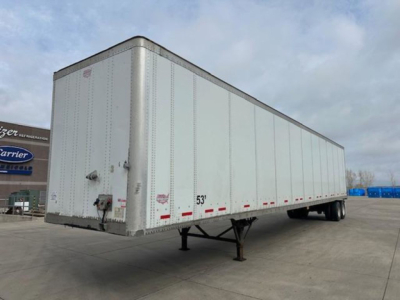 Trailer showing a long white 53' Wabash van semi-trailer with chassis and landing gear visible, side markings and reflectors