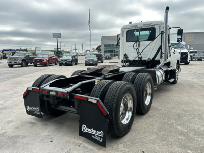 Truck chassis and cab of a 2020 Mack PI64T conventional daycab viewed from rear-right, showing dual rear axles, fifth wheel area, and mudflaps with Bruckners logo.
