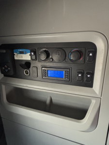 Kenworth T680 interior dashboard view showing climate controls and digital stereo display.
