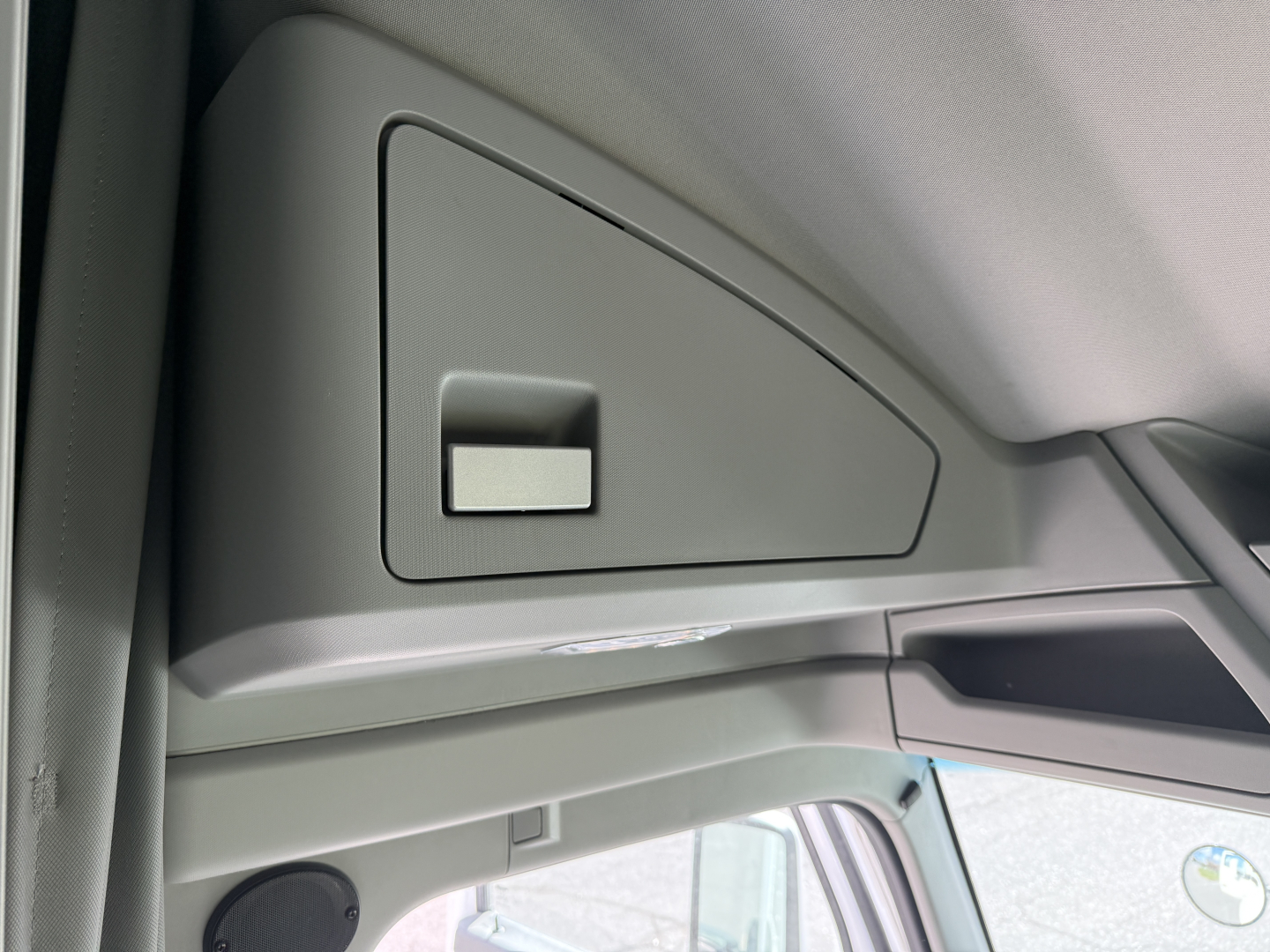 Kenworth T680 interior front passenger area showing overhead storage compartment with switch and dash panel