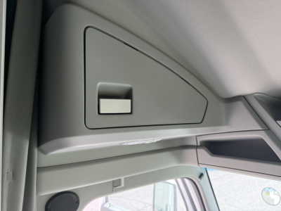 Kenworth T680 interior front passenger area showing overhead storage compartment with switch and dash panel