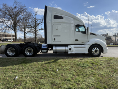 Kenworth T680 sleeper cab tractor in profile view showing side tanks, wheels, and exhaust, with no text visible