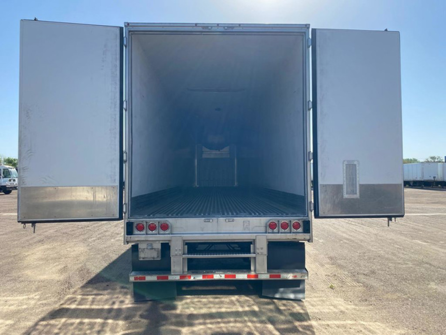 Refrigerated trailer cargo area open with doors wide, empty interior, Great Dane 2020 reefer unit visible at rear.