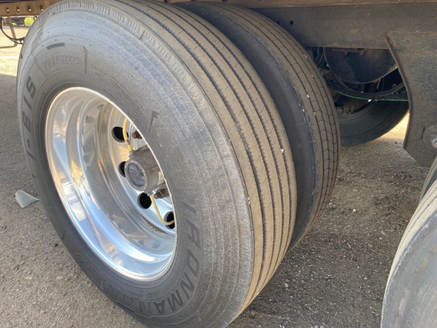 Great Dane reefer trailer wheel assembly showing dual tires mounted on polished chrome rim with tire tread and identification on sidewall.