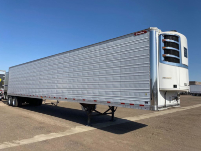 Reefer trailer by Great Dane with a front refrigeration unit showing exterior silver corrugated walls and landing gear, in-service condition.