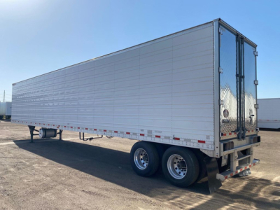 Great Dane reefer trailer with tandem rear wheels, side metal panels, and double rear doors.