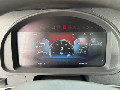Kenworth T880 instrument cluster display showing digital gauges and warning icons.