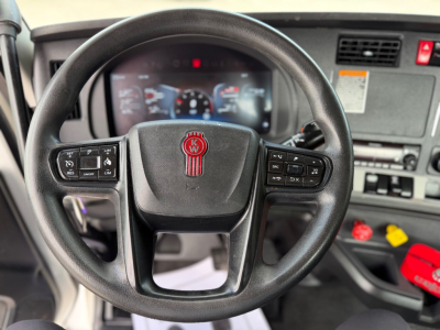 Kenworth T880 steering wheel and dashboard inside cab showing steering controls and instrument cluster.