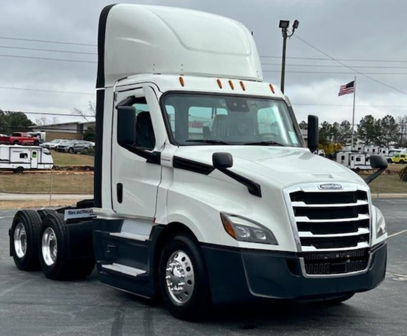 Freightliner Cascadia 126 day cab tractor showing white cab with black lower bumper and chassis, 6-wheel configuration, no visible text on door