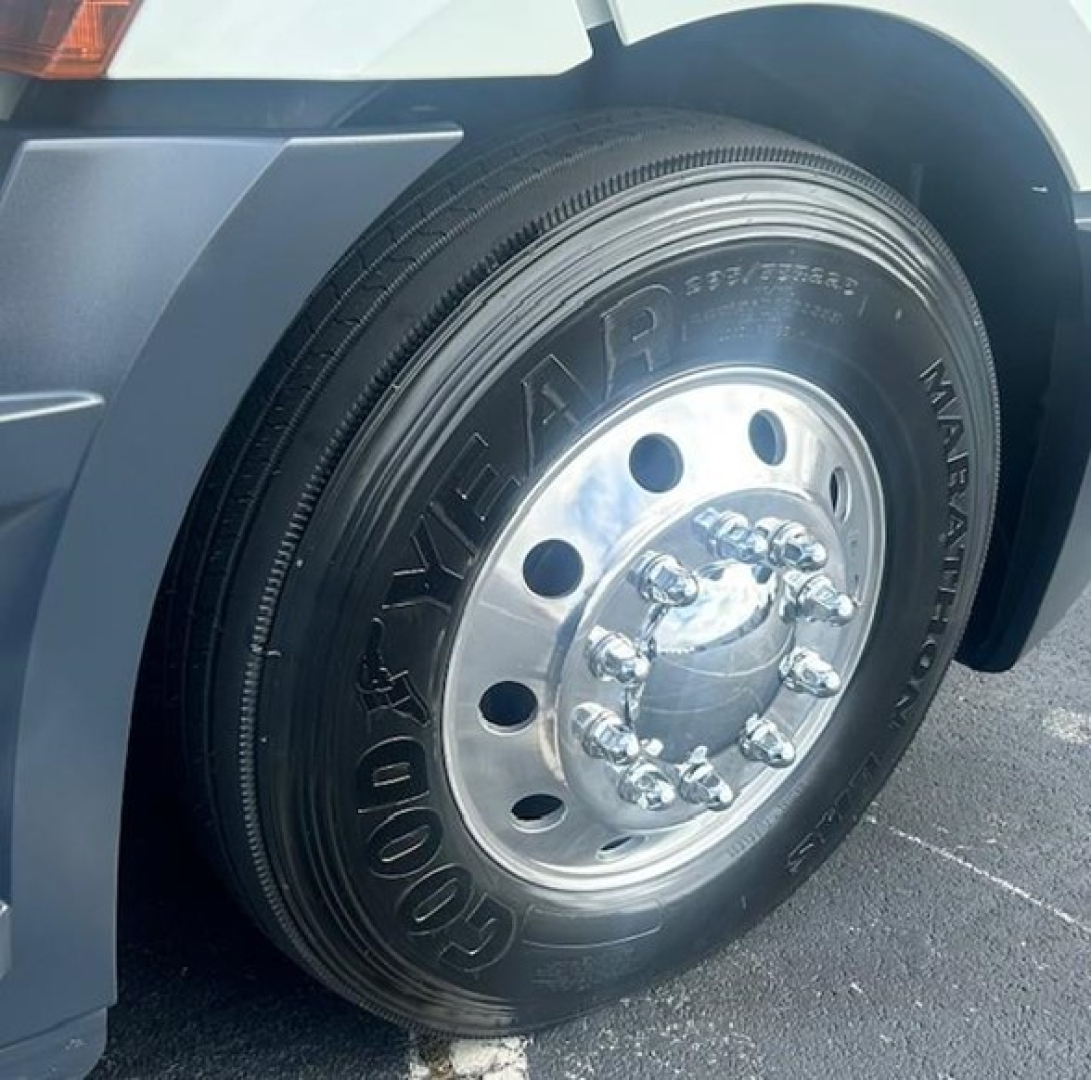 Goodyear Marathon front wheel assembly of a 2022 Freightliner Cascadia 126 Day Cab showing front tire with rim and hub, partial fender, and headlight area.
