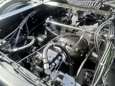 Truck engine bay with hoses and components visible; shows intake manifold, belts, hoses, and wiring in a Cascadia 126.
