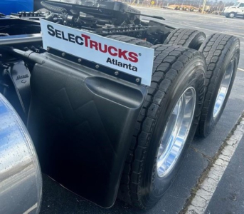 Freightliner Cascadia 126 tractor rear dual tires and mudflap with SelecTrucks Atlanta sign on saddle tank area