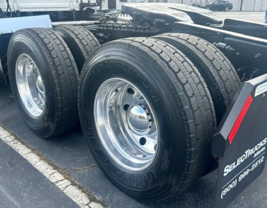 Truck rear dual wheels on a 2022 Freightliner Cascadia 126 chassis showing dual tires and chrome rims.