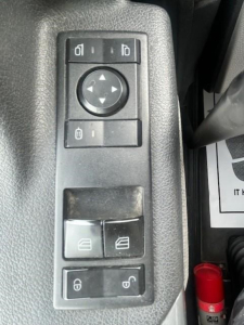 Trucker door panel controls in view showing window/lock switches and circular navigation pad.