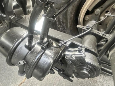 Freightliner Cascadia 126 drivetrain component showing powertrain housing and hydraulic lines