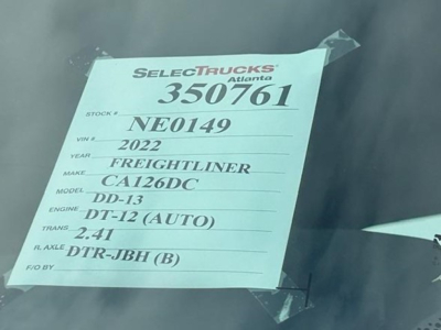 Tag on dash window showing details: Stock 350761, VIN NE0149, Year 2022, Make Freightliner, Model Cascadia DD-13, Engine DT-12 (AUTO), Trans 2.41, R. Axle DTR-JBH (B).