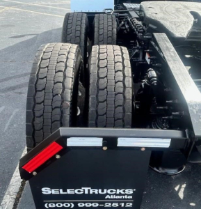 Truck rear showing dual tires and chassis with SelectTrucks Atlanta plate and stock number.