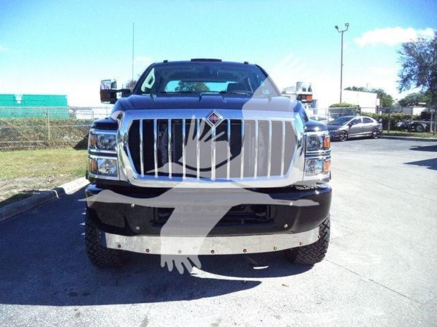 Front view of a new 2023 International CV truck showing chrome grille, large bumper, and International emblem on the grille.