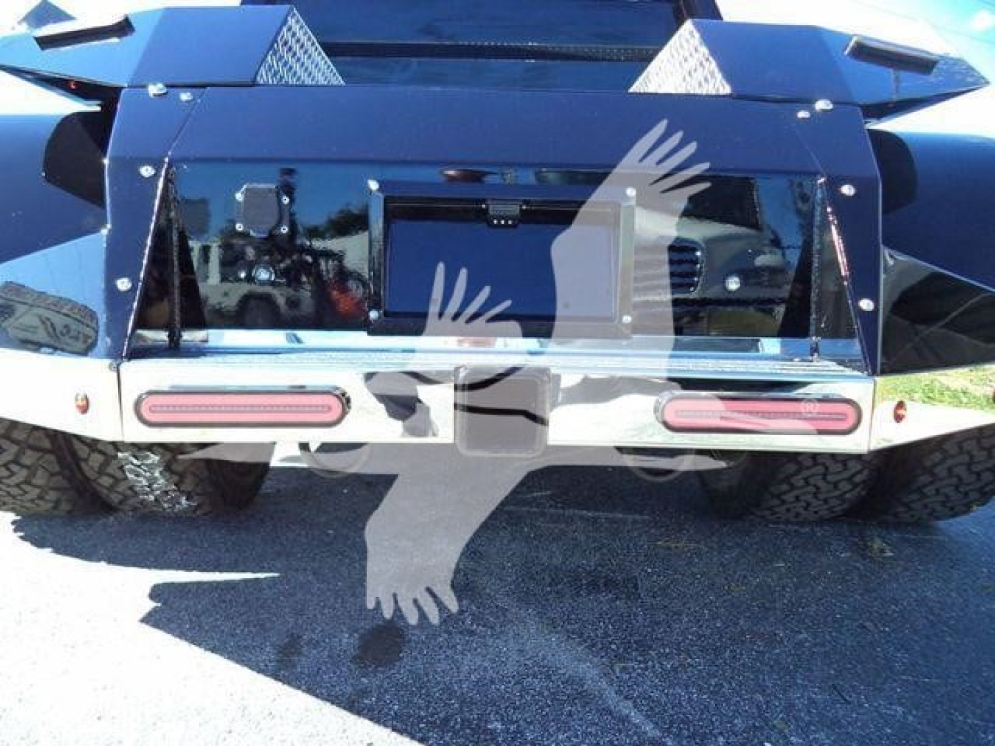 Rear view of a 2023 International CV truck bed showing taillights, bumper, and spare tire wells.