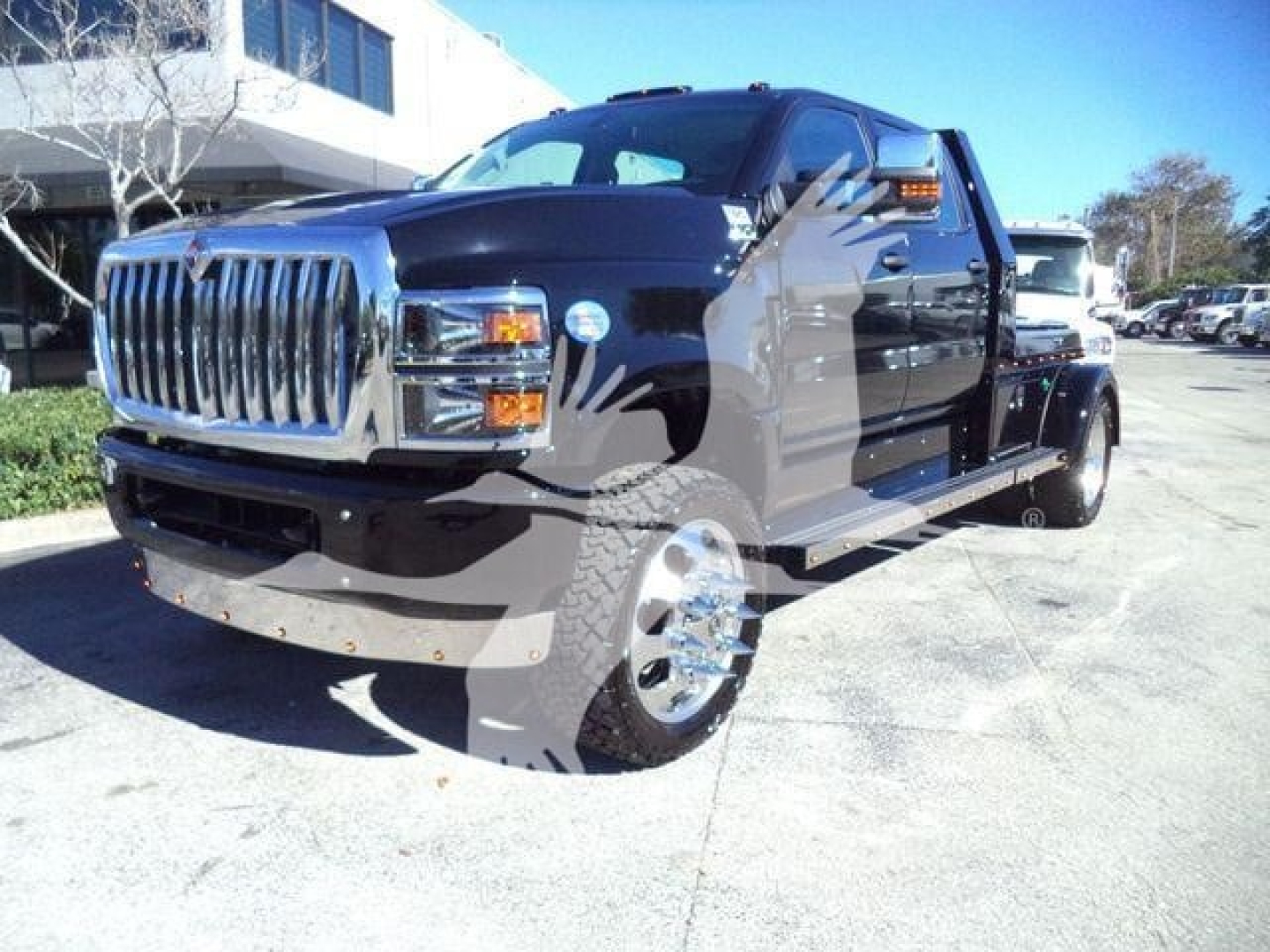 2023 International CV truck in dark blue, front-left angle, chrome grille, dual rear wheels, outdoors at dealership.