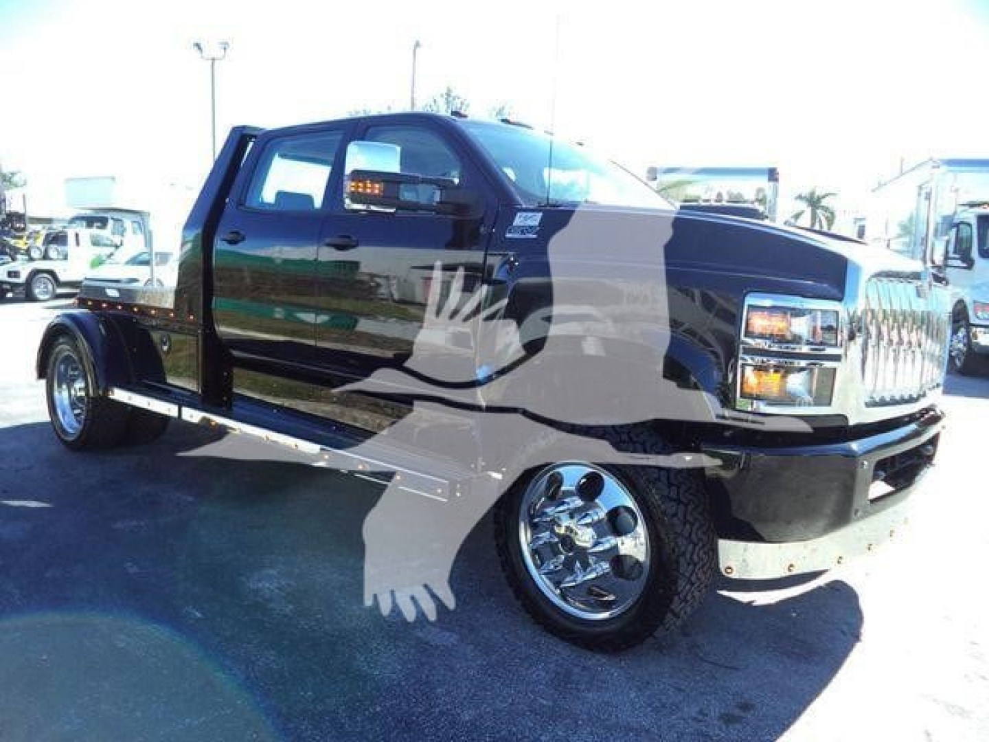 2023 International CV truck in showroom lot showing dual rear wheels, black cab with chrome bumper, stepped side, and cargo bed.