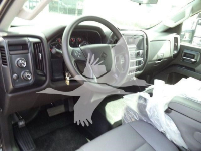 Interior view of a 2023 International CV truck cab with steering wheel, dashboard, and front seats.