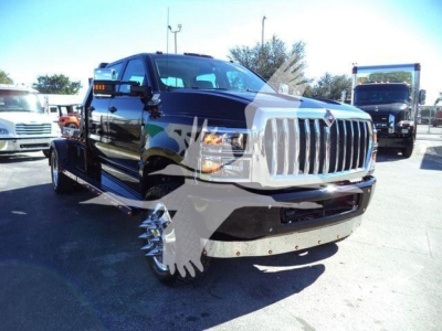 Truck showing front-left view of a black 2023 International CV with chrome grille, lifted stance, and heavy-duty front bumper.