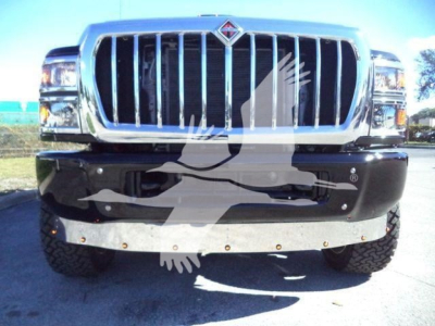 Front view of a 2023 International CV truck showing chrome grille, large bumper, and dual headlights.