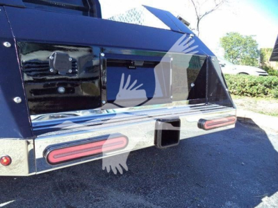 Trucks rear end showing cargo bed and bumper area with taillights and hitch receiver.