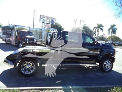 Side view of a black 2023 International CV truck with extended cab, chrome wheels, and a large watermark across the image.