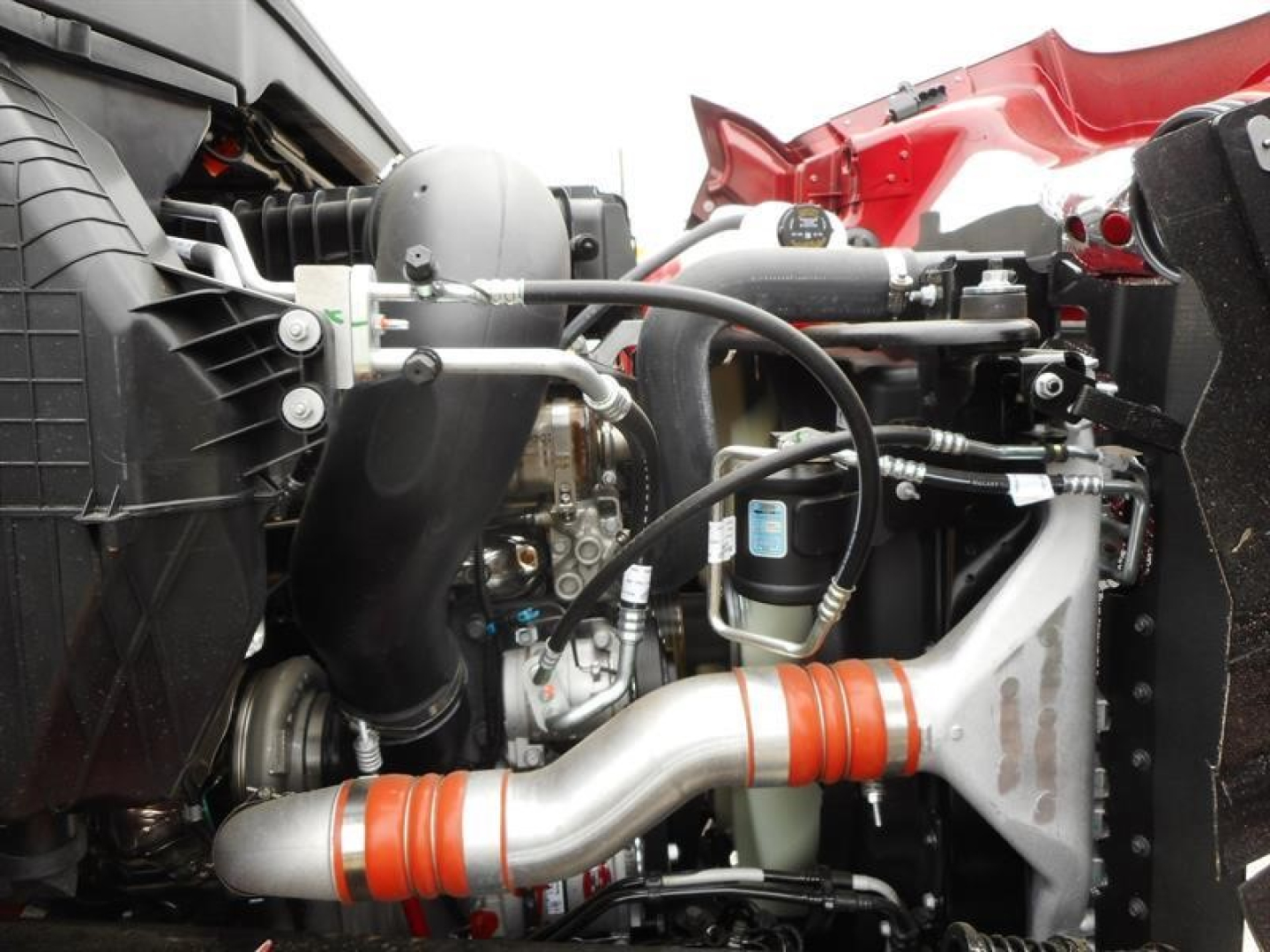 Engine bay of a Western Star 47X dump truck showing intake pipes, hoses, and turbocharger components.