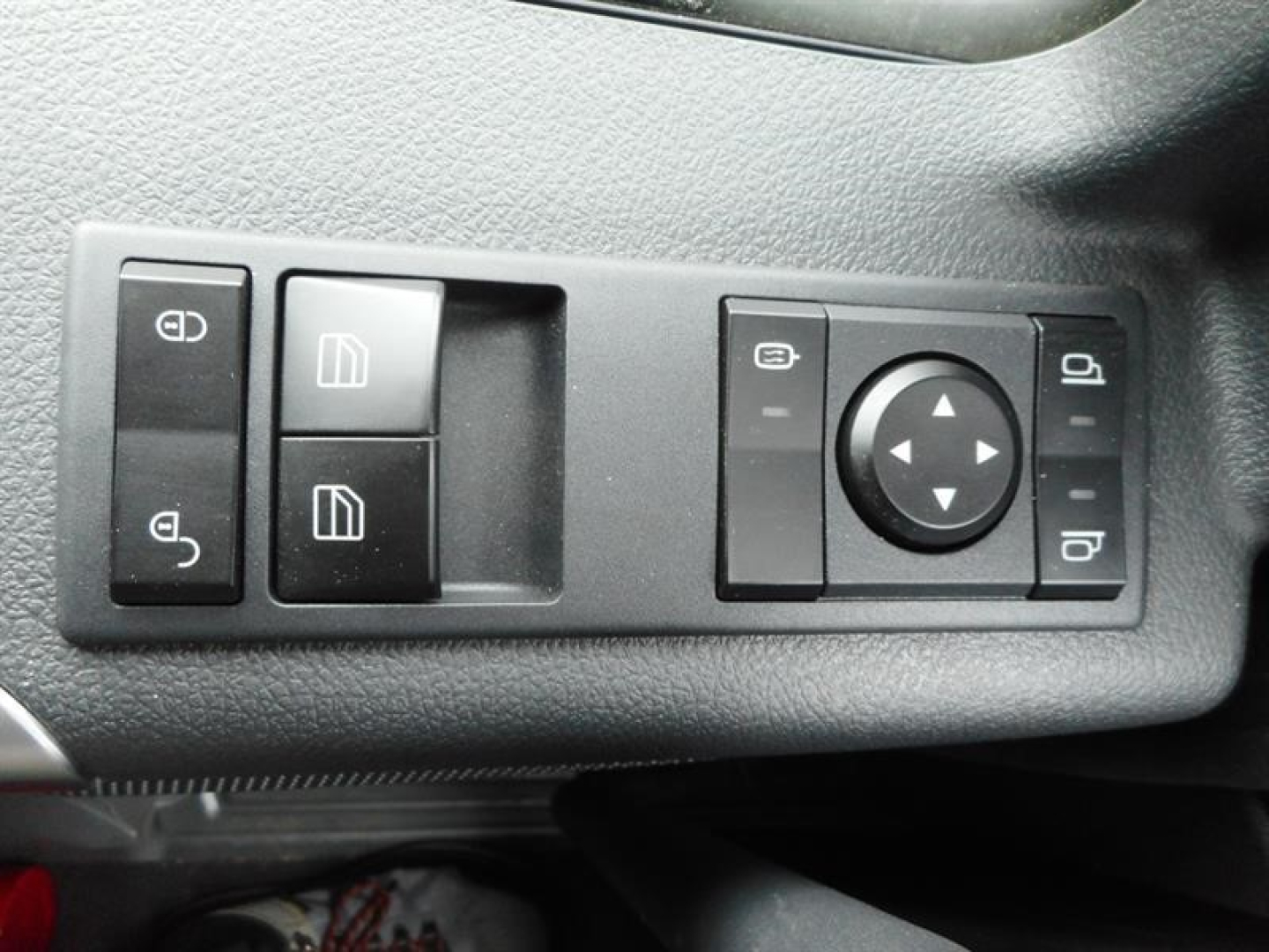 Truck interior window controls panel with mirror adjustment and window switches in a Western Star cab.
