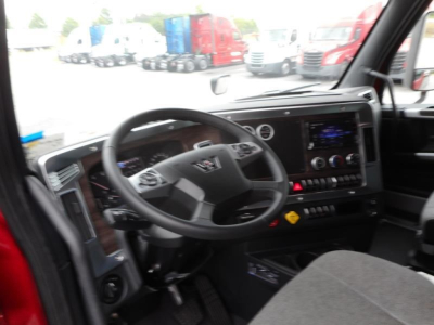 Cab interior of a new 2027 Western Star 47X truck showing steering wheel, digital dashboard, center touchscreen, and controls.