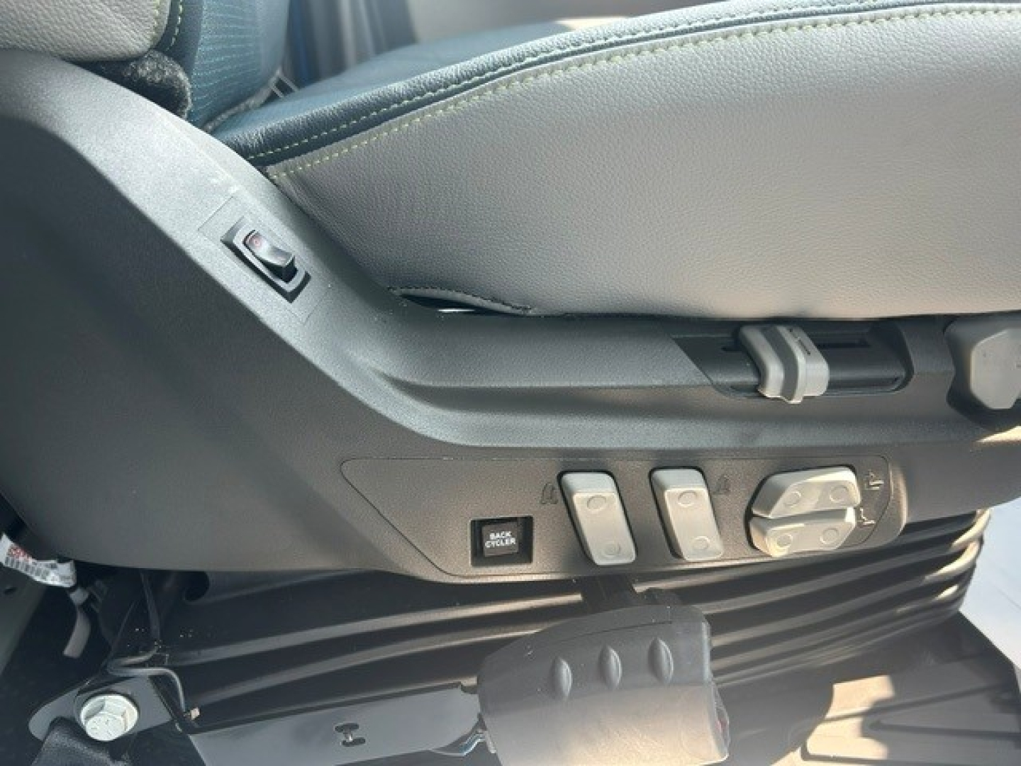 Volvo VNL64T840 cab interior showing seat adjustment controls and lumbar support switches.