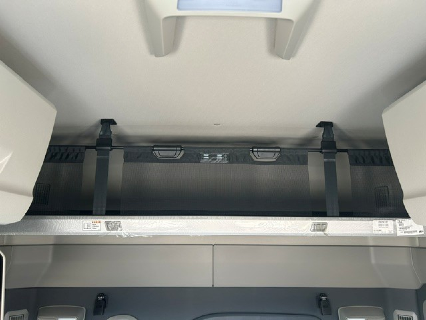 Volvo VNL64T840 sleeper truck interior view showing storage cabinet and overhead components.