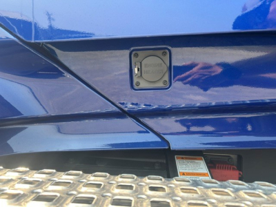 Volvo VNL truck fuel cap access panel and step area showing fuel cap label and warning sticker.