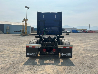 Back view of a new Volvo VNL64T840 tractor cab with blue container, dual rear wheels, and mud flaps labeled Bruckners Equipment.