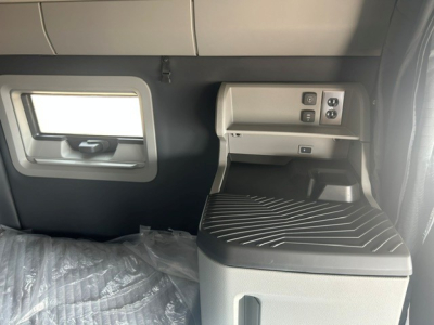 Volvo VNL64T840 interior cab area showing window, control panel, and seating surface with text and switches.