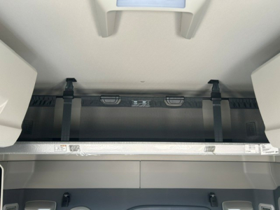 Volvo VNL64T840 sleeper truck interior view showing storage cabinet and overhead components.