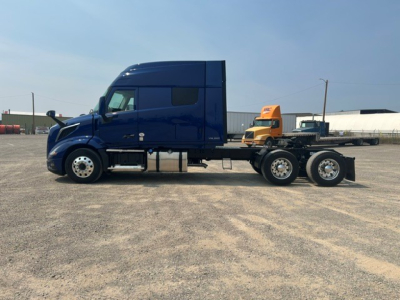 Volvo VNL64T840 tractor-trailer cab side profile showing blue sleeper tractor with orange day cab atop single-frame chassis.