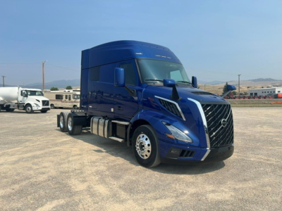 Volvo VNL64T840 truck shown in blue exterior, front-left view with sleeper cab and large grille.