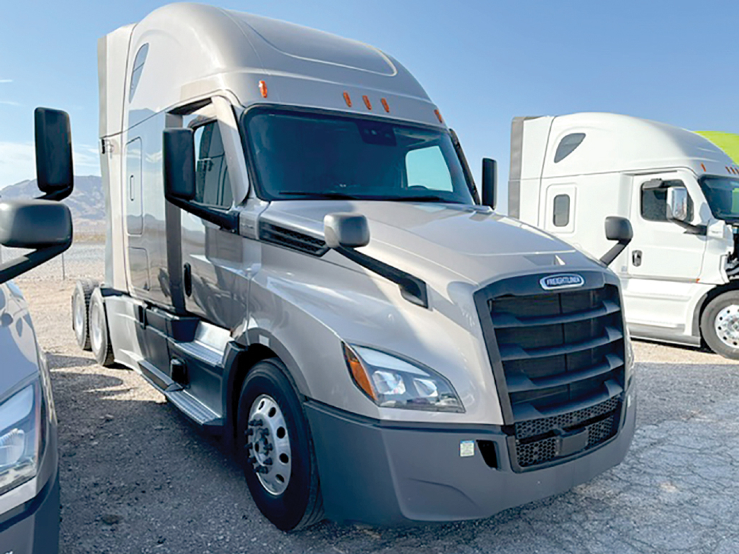 Freightliner Cascadia126 semi-truck in a used condition with silver exterior, front grille, cabover, and chrome mirrors. VIN 3AKJHHDR7RSUX7067 visible in listing.